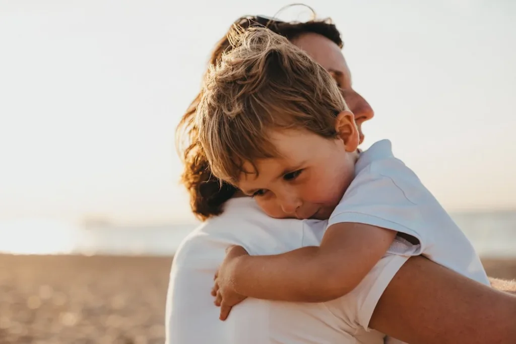 A child being comforted by an adult