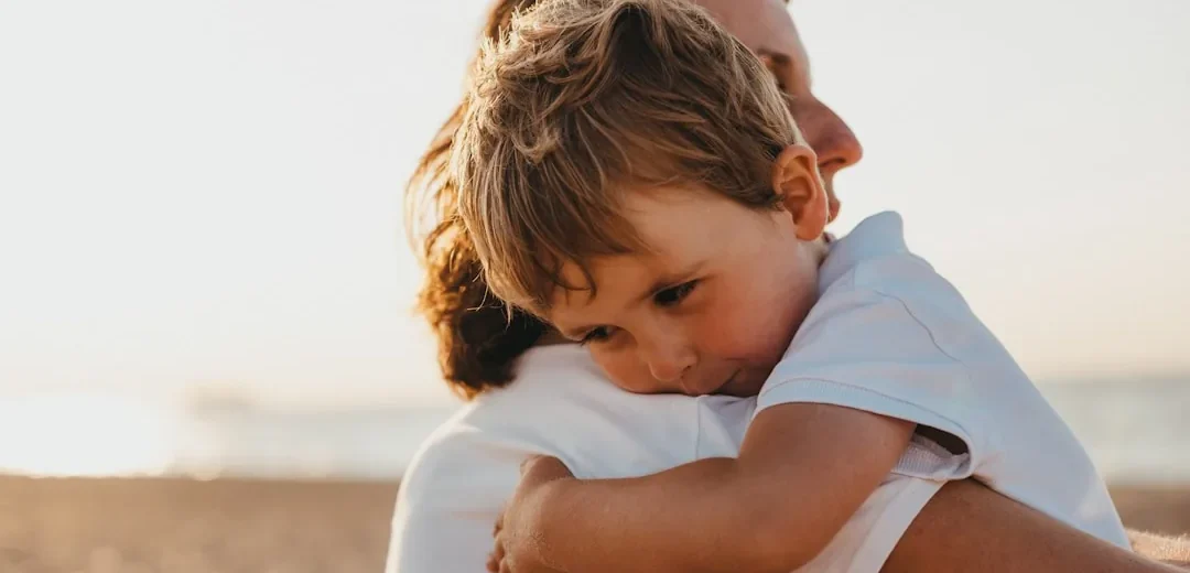 A child being comforted by an adult