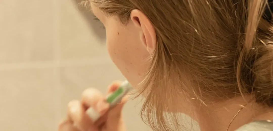 A child brushing their teeth