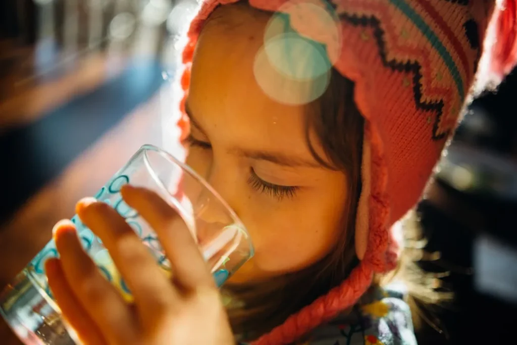 A child drinking a glass of water
