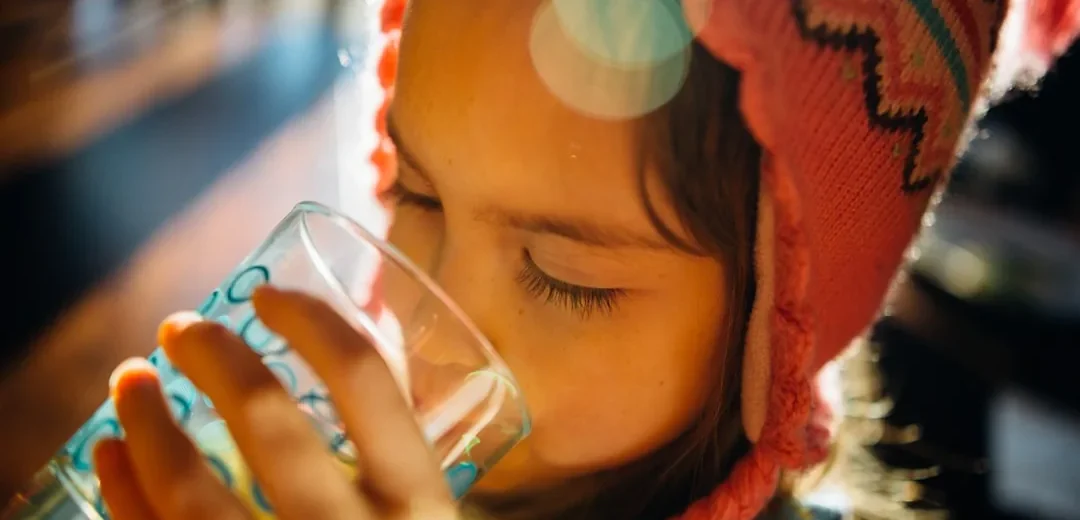 A child drinking a glass of water