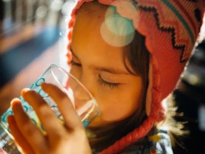 A child drinking a glass of water
