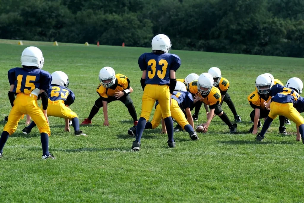 Children playing sport wearing protective gear