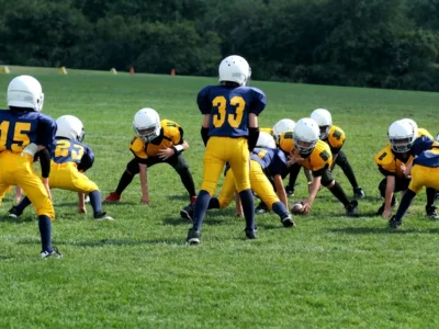 Children playing sport wearing protective gear